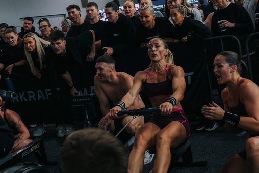 The room cheering a member on the rower