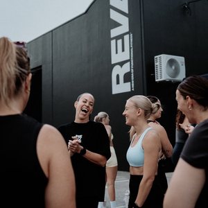 A REVL coach greeting members as they arrive